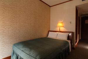 Ένα ή περισσότερα κρεβάτια σε δωμάτιο στο Hotel Viamare Kobe