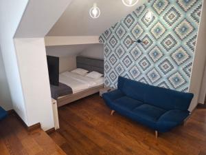 a living room with a couch and a bed at Апартаменти Вілла Гор in Bukovel