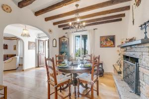 a dining room with a table and a fireplace at Casa Naima: Family House | Terrace & Peaceful Location - Happy Rentals in Breno