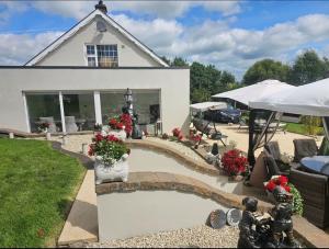 a house with a pond in front of a house at Dernvale House -Double Room sleeps 2 in Mullinderg