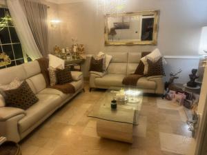 a living room with couches and a coffee table at Dernvale House -Double Room sleeps 2 in Mullinderg