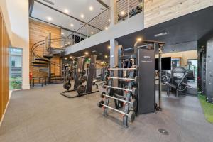 a gym with several treadmills and weights at AVE Tampa Riverwalk in Tampa
