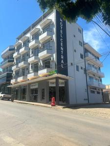 a tall building with a for lease sign on it at Hotel Central in Boa Esperança
