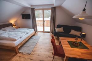 a bedroom with a bed and a table and a couch at Der Sagbauer in Donnersbachwald +36 photos