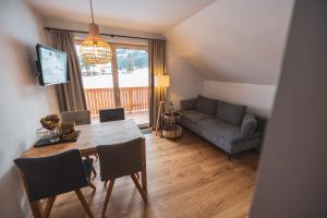 a living room with a table and a couch at Der Sagbauer in Donnersbachwald