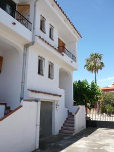 a white house with stairs and a gate at Inocencia in Alcossebre