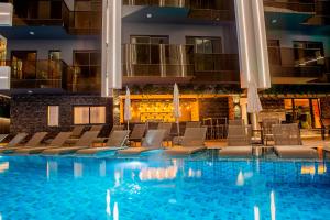 a hotel pool with chairs and a bar at SA Apartments! Cleopatra Beach Duplex with Terrace in Alanya
