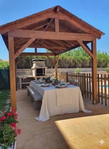 a table under a wooden pavilion on a deck at Casa Galiñanes in Portonovo