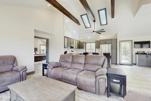a living room with a couch and a table at Outdoor Wonderland! Home 12 Mi to Lake George in Fort Ann