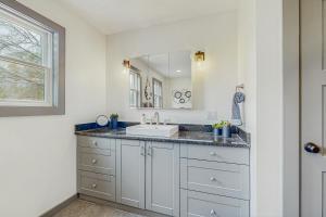 a bathroom with a sink and a mirror at Outdoor Wonderland! Home 12 Mi to Lake George in Fort Ann +21 photos