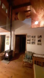 a room with a fireplace and a couch and a chair at Cabaña Vista Las Bravas in Recinto +24 photos