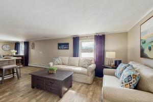 a living room with a couch and a table at 12 Mi to Lake George! Quiet Adirondack Escape in Fort Ann