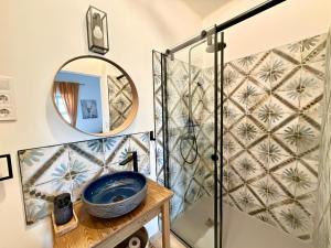 a bathroom with a shower and a blue sink at Kökény Kunyhó in Kisszékely +4 photos