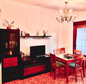 a dining room with a table and a television at La casa de Tentenecio in Salamanca