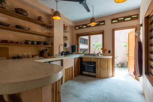 a kitchen with a large island in a room at Casa Maradi-Arena in Mazunte