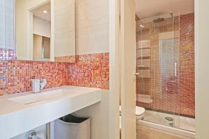 a bathroom with a sink and a toilet and a shower at Beach Penthouse Sitges in Sitges +20 photos