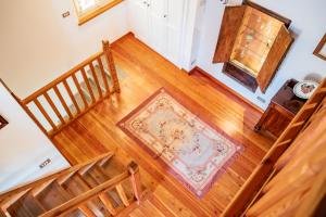 an overhead view of a staircase with a rug on a wooden floor at La Meridiana in Carrù