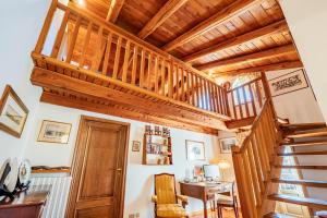 a staircase in a home with wooden ceilings at La Meridiana in Carrù +31 photos
