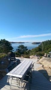 a table with benches and a view of the water at Utsikten i Bua in Kungshamn +13 photos