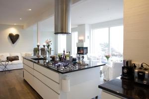 a kitchen with a stove top island in a room at Utsikten i Bua in Kungshamn
