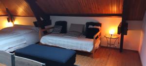 a small bedroom with a bed and a table at La Petite Ecole de la Baie in Pontorson