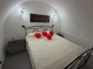 a bedroom with a bed with red hearts on it at Antica Dimora in Taranto