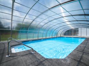 an indoor swimming pool with a glass ceiling at Saddleview Bed & Breakfast in South Sterling