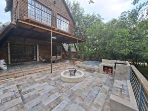 an outdoor patio with a fire pit and a building at Ratel Retreat in Marloth Park
