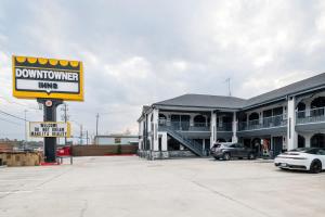 a building with a sign in a parking lot at Downtowner Inns - Houston Downtown & Convention Center in Houston