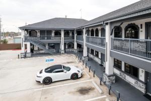 a white car parked in front of a building at Downtowner Inns - Houston Downtown & Convention Center in Houston
