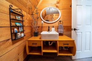 a bathroom with a sink and a mirror at Forget Me Not Aframe-Cave Run in Wellington +39 photos