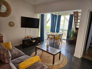 a living room with a couch and a table at La splendide Coralline in La Saline Les hauts 