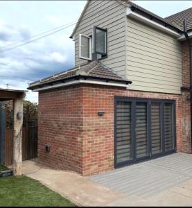 a brick house with a window and a garage at Forest view in Staunton