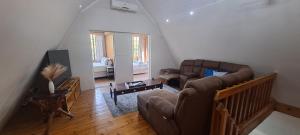 a living room with a couch and a table at Ratel Retreat in Marloth Park