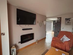 a living room with a flat screen tv on the wall at Forest view in Staunton