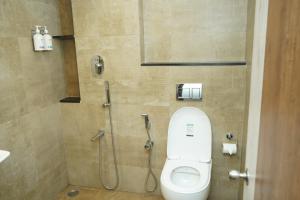 a bathroom with a toilet and a shower at Sesha Residency in Chennai