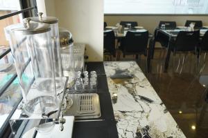 a table with a blender on top of a marble counter at Sesha Residency in Chennai +40 photos