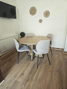 a wooden table and chairs in a room at Chez collette in Chablis