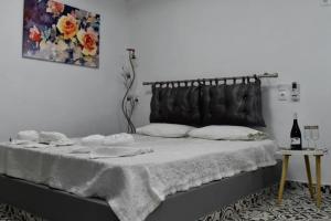 a bedroom with a bed with a blanket on it at Stella's House in Skopelos Town