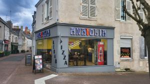 a store front of a restaurant on a street at Studio meublé centre ville de mer in Mer