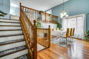 a dining room with a staircase and a table at Deck & Outdoor Dining! Spacious St Paul Getaway in North Saint Paul