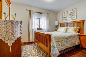 a bedroom with a large bed and a window at Deck & Outdoor Dining! Spacious St Paul Getaway in North Saint Paul