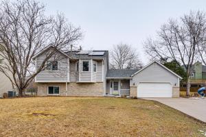 a house with a yard with a driveway at Deck & Outdoor Dining! Spacious St Paul Getaway in North Saint Paul