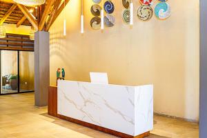 a counter in a room with plates on a wall at Palm Beach Resort in Serekunda