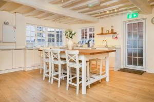 a kitchen with a large wooden table and chairs at Hambleton House in Derby