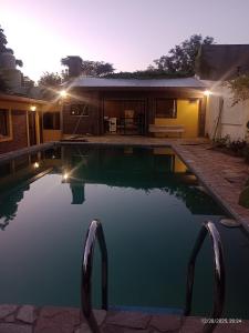 a swimming pool in front of a house at Ye muá, ye tuá in City Bell