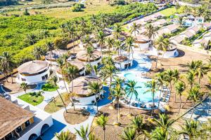an aerial view of a resort pool with palm trees at Palm Beach Resort in Serekunda +37 photos