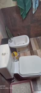 a bathroom with a white toilet and a sink at Ye muá, ye tuá in City Bell +11 photos