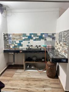 a room with a counter with tiles on the wall at swagatom Homestay in Jorhat