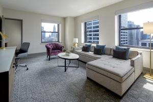 a living room with a couch and a table at InterContinental Chicago Magnificent Mile by IHG in Chicago
